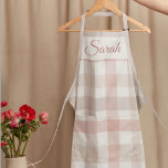 Pastel Pink Plaid Custom Name Kitchen Apron<br><div class="desc">"Add a touch of sweetness to your kitchen with this Pastel Pink Plaid Custom Name Kitchen Apron. Combining cozy plaid charm with personalized style,  this apron keeps you protected while cooking,  baking,  or hosting. Make it uniquely yours by adding your name,  nickname,  or a special message."</div>