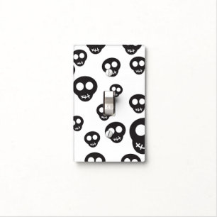 Pattern with black skulls on white light switch cover
