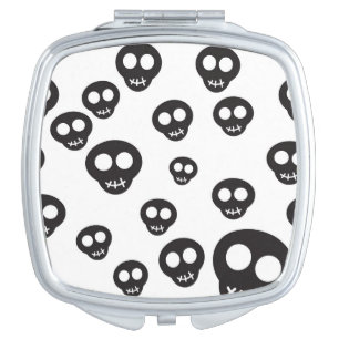 Pattern with black skulls on white makeup mirror