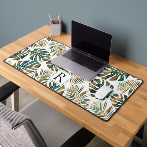 Patterned tropical leaves teal gold brush strokes desk mat