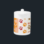 Paw Prints cute Dog Lovers Teapot<br><div class="desc">Design with a cute pattern of dog paw prints in orange and yellow and warm colours. This design looks as though a dog has walked over the product ! For dog lovers everywhere.</div>