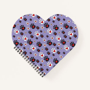 Paw prints with red hearts on blue notebook