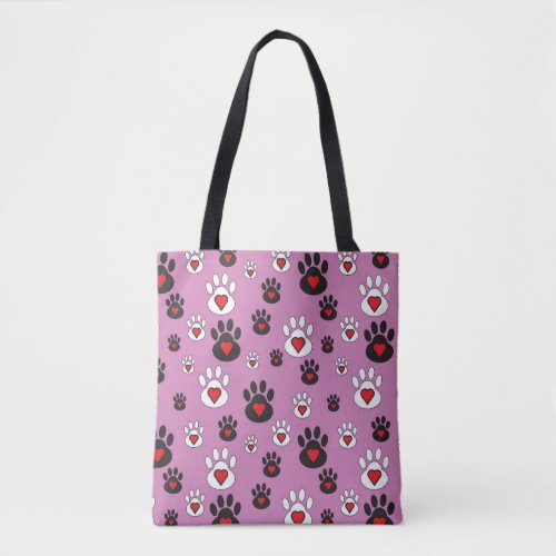 Paw prints with red hearts on pink  tote bag