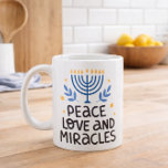 Peace Love and Miracles Jewish Holiday Gift Cup<br><div class="desc">Hanukkah coffee mug featuring a modern menorah illustration paired with the phrase “Peace Love and Miracles.” The clean blue and gold design feels festive without being overly seasonal, making it a meaningful piece for both holiday celebrations and everyday use. Printed on a classic ceramic mug, the artwork stands out clearly...</div>