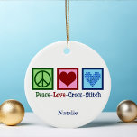 Peace Love Cross Stitch Cute Personalized Ceramic Ornament<br><div class="desc">Cute cross stitching ornament gift for someone who loves to create things. This custom Peace Love Cross Stitch gift features a peace sign,  heart,  and a pretty cross-stitch pattern heart.</div>