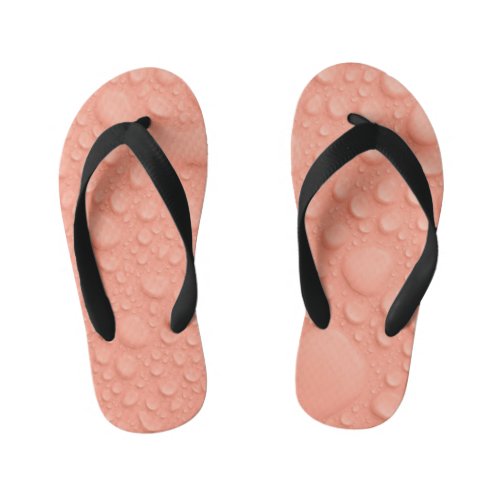 Peach colored background with water drops kids flip flops