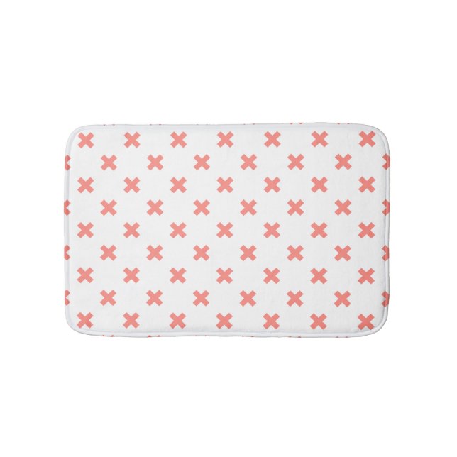 Peach cross stitches on white bath mat (Front)