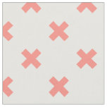 Peach cross stitches on white fabric