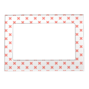Peach cross stitches on white magnetic frame