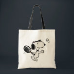 Peanuts | Snoopy Plays Tennis Tote Bag<br><div class="desc">In the Peanuts comic strip and animated films,  Snoopy is often depicted playing tennis against his owner Charlie Brown or other characters like Linus and Lucy. This design showcases Snoopy's athletic abilities and competitive spirit in a humorous way.</div>