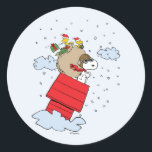 Peanuts | Snoopy the Flying Ace at Christmas Classic Round Sticker<br><div class="desc">Celebrate the holidays and your love of Peanuts with this cute design featuring the Red Baron delivering toys at Christmas.</div>