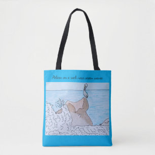 Pelican on a rock near ocean waves tote bag