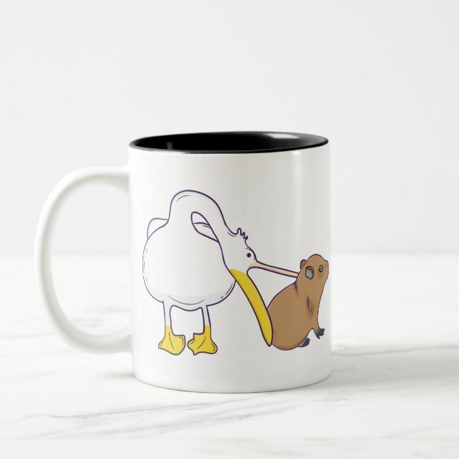 Pelican Tries to Eat Capybara Funny Cute Kawaii Two-Tone Coffee Mug (Left)