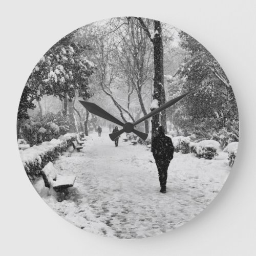 People at park in snowy winter day large clock