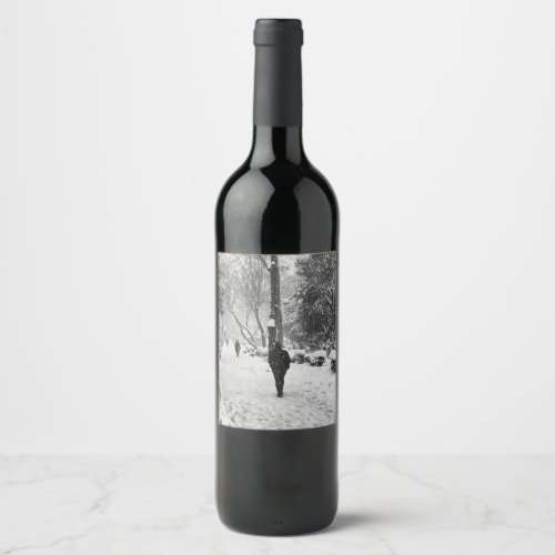 People at park in snowy winter day wine label