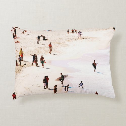 People on beach in the morning accent pillow