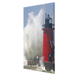 People on jetty watch large breaking waves in canvas print