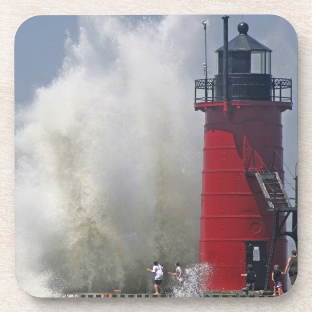 People on jetty watch large breaking waves in coaster (Front)