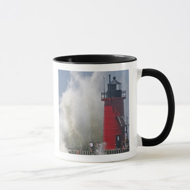 People on jetty watch large breaking waves in mug (Right)