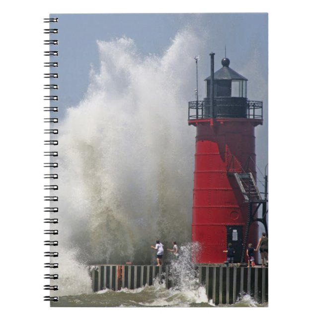 People on jetty watch large breaking waves in notebook (Front)