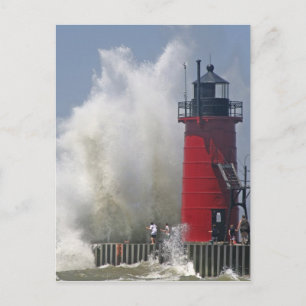 People on jetty watch large breaking waves in postcard
