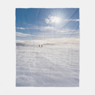 People walking over snow, Iceland Fleece Blanket