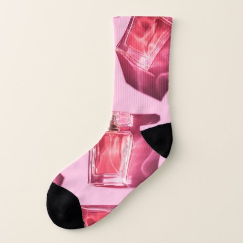 Perfume bottles pink background flatlay socks