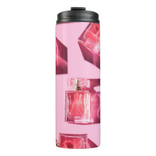 Perfume bottles, pink background, flatlay thermal tumbler