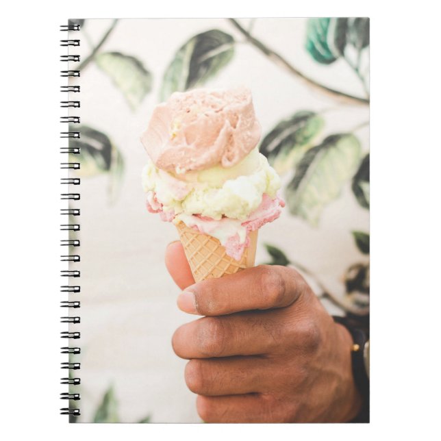 Person holding ice cream cone with three flavors o notebook (Front)