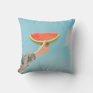 Person holding sliced watermelon throw pillow