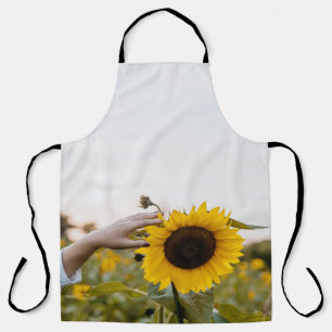 Person holding sunflower apron
