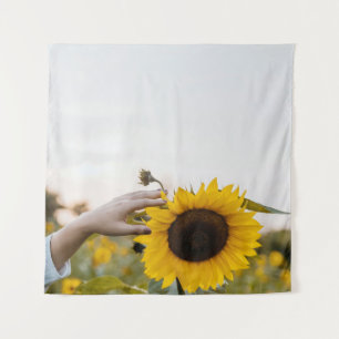Person holding sunflower tapestry