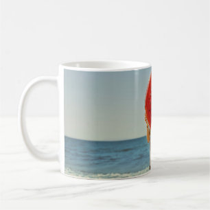 Person holding watermelon-themed inflatable ring coffee mug