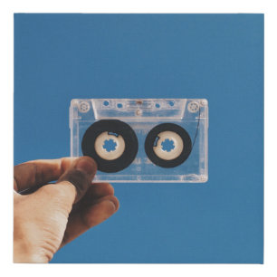 Person holding white and black cassette tape faux canvas print
