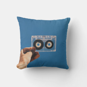 Person holding white and black cassette tape throw pillow