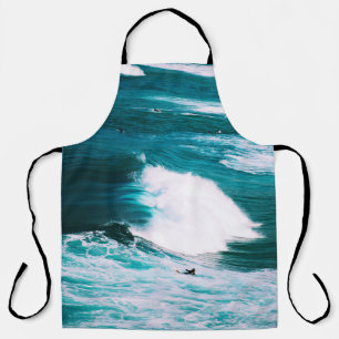 Person on surfboard with ocean waves apron
