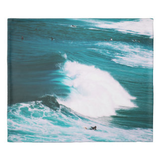 Person on surfboard with ocean waves duvet cover