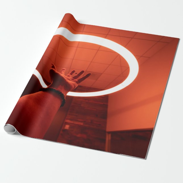 PERSON REACHING ROUND TURNED-ON FLUORESCENT LAMP I WRAPPING PAPER (Unrolled)