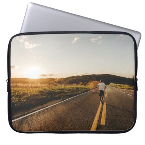 Person running in road in the morning laptop sleeve