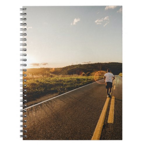 Person running in road in the morning notebook