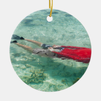 Person snorkeling in clear water ceramic ornament