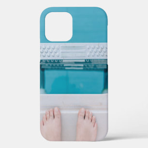Person standing on swimming pool ladder iPhone 12 case