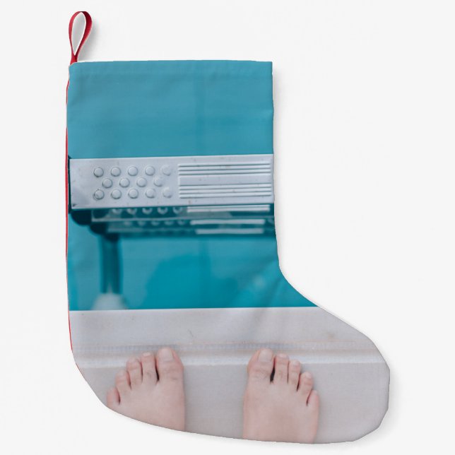 Person standing on swimming pool ladder small christmas stocking (Front)