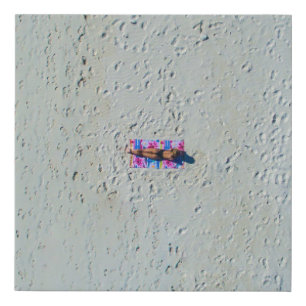 Person sunbathing at the beach faux canvas print