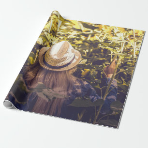 Person wearing white hat beside sunflower fields wrapping paper