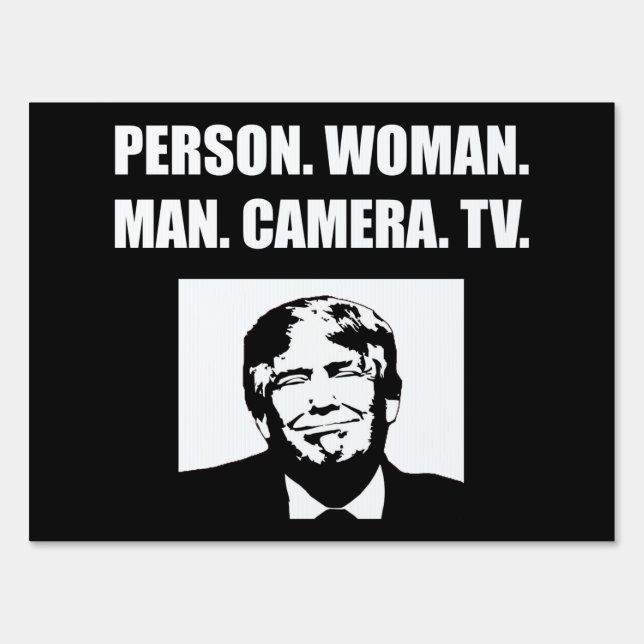 Person. Woman. Man. Camera. TV. Anti-Trump Sign (Front)