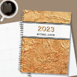 Personalised Gold 2023 Planner<br><div class="desc">This elegant Planner is decorated with a textured effect print in faux gold.
Customize it by changing the name and the year.</div>