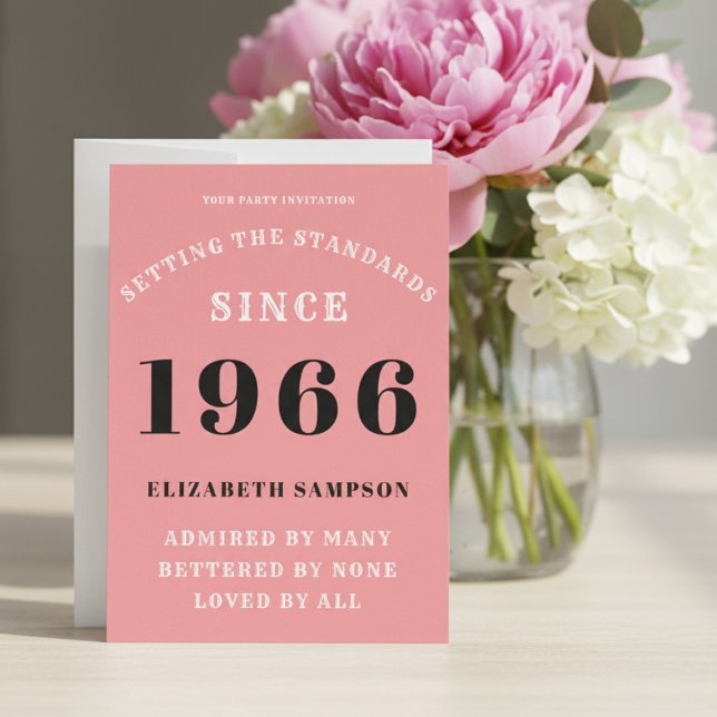 Personalized 60th Birthday 1966 Add Your Name Pink Invitation (1966 pink birthday invitation on a table with flowers.)