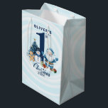 Personalized Baby’s First Christmas  Medium Gift Bag<br><div class="desc">Celebrate your baby boy’s magical first Christmas with this heartwarming winter design! Featuring a cheerful Santa Claus, playful snowman, gingerbread man, wrapped gifts, and a festive Christmas tree, all surrounding a bold navy “1st” in the center. Personalize it with your child’s name and the year to create a memorable keepsake...</div>