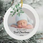 Personalized Baby's First Christmas Foliage Photo Ceramic Ornament<br><div class="desc">This Baby's First Christmas Ornament is decorated with green watercolor mistletoe. Easily customizable with your baby's photo, name, and year. Use the Design Tool to change the text size, style, or color. Because we create our artwork you won't find this exact image from other designers. Original Watercolor © Michele Davies....</div>